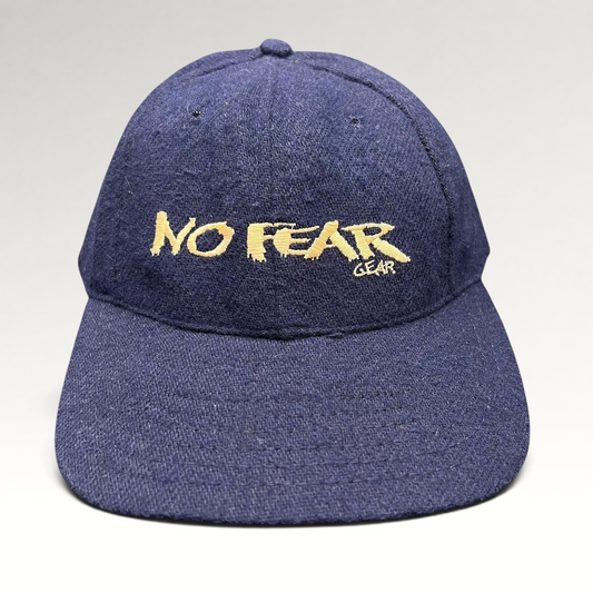 Raree Finds vintage 90s navy wool-blend snapback hat with gold No Fear Gear embroidery and structured six-panel design.