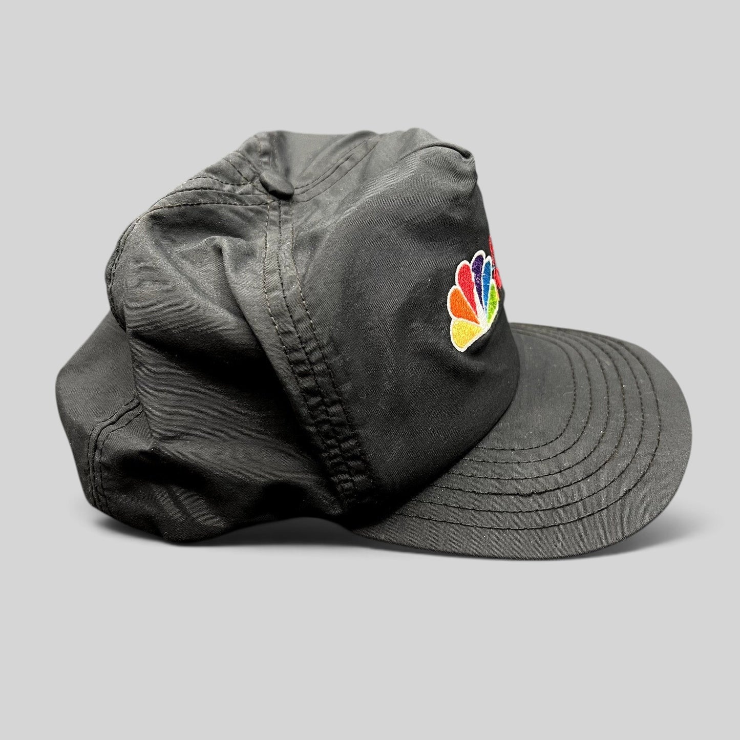Raree Finds vintage 90s black nylon NBC News snapback hat with embroidered colorful peacock logo