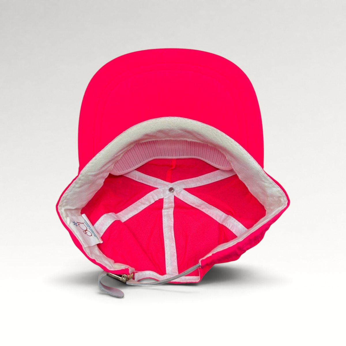 Raree Finds vintage 80s neon pink nylon ski hat with white interior lining and adjustable metal clasp strap