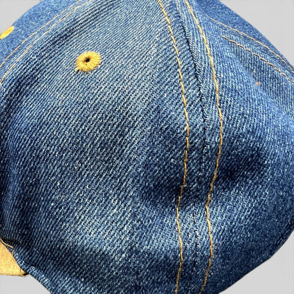 Raree Finds vintage Nestlé Otto Cap featuring distressed indigo denim with golden stitching and tan suede brim detail.