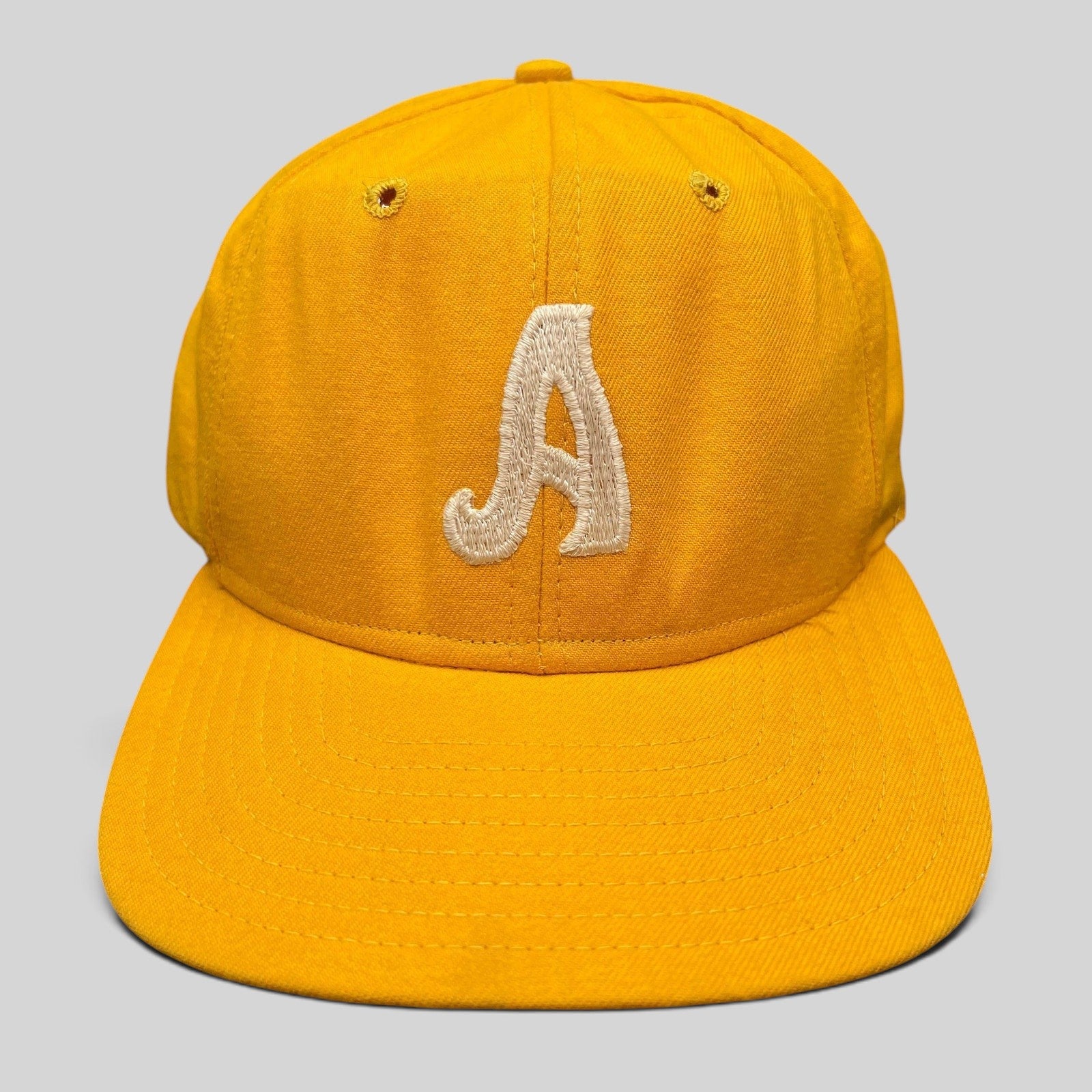 Raree Finds vintage New Era Pro Model A snapback hat in gold with embroidered white letter and green undervisor