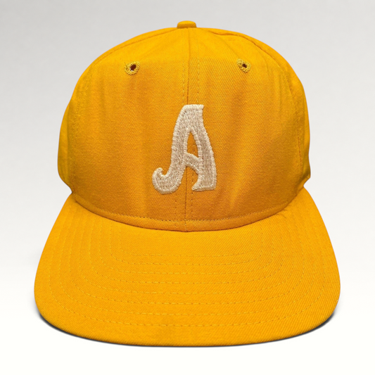 Raree Finds vintage New Era Pro Model A snapback hat in gold with embroidered white letter and green undervisor