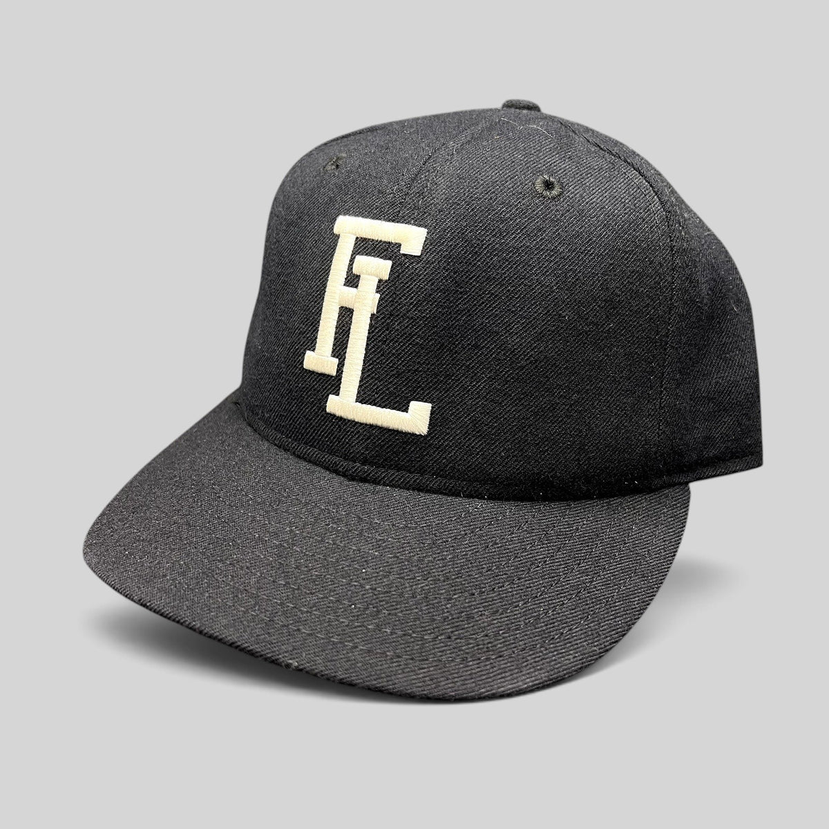 Raree Finds vintage New Era USA made navy snapback hat with interlocking FL embroidery and a gray Dupont visor