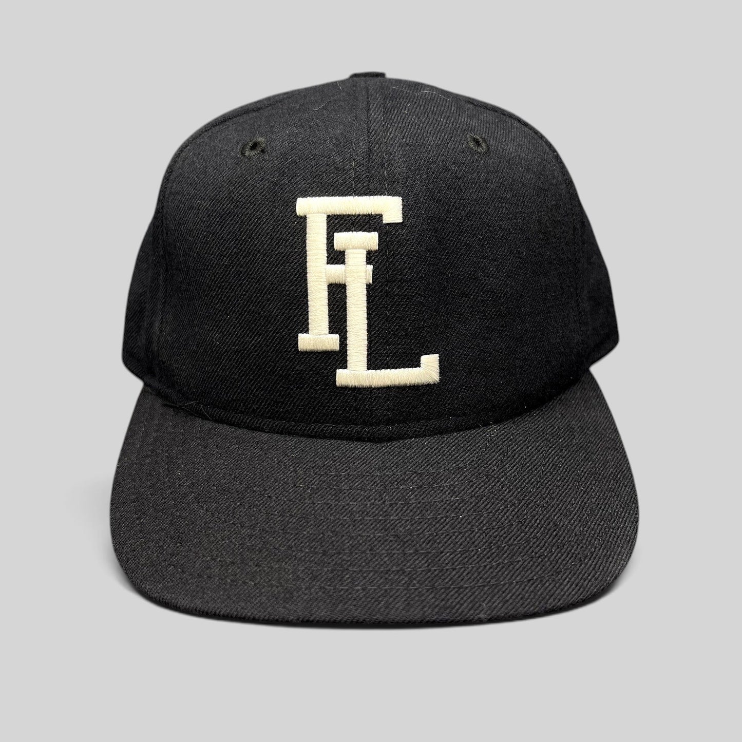 Raree Finds vintage New Era USA made navy snapback hat with white interlocking FL embroidery and gray undervisor