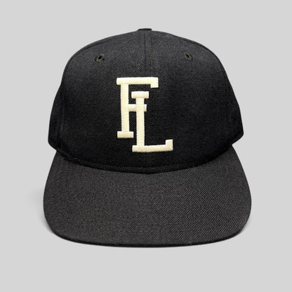 Raree Finds vintage New Era USA made navy snapback hat with white interlocking FL embroidery and gray undervisor