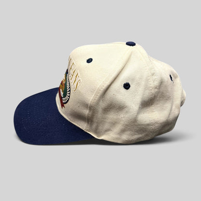 Raree Finds vintage New Orleans snapback hat with cream crown, navy brim, and embroidered riverboat graphic.