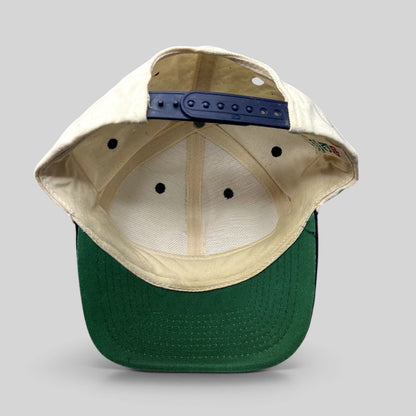 Raree Finds vintage New Orleans snapback hat showing the interior cream crown, navy snap closure, and green undervisor.