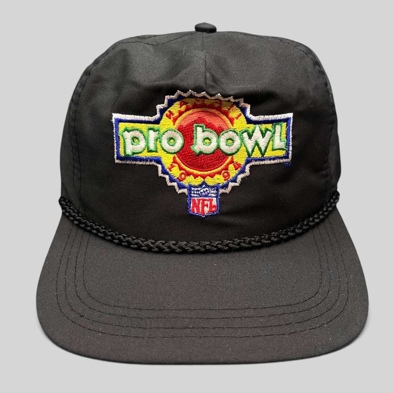 Raree Finds vintage black NFL Pro Bowl snapback hat with braided rope detail and colorful embroidered logo.