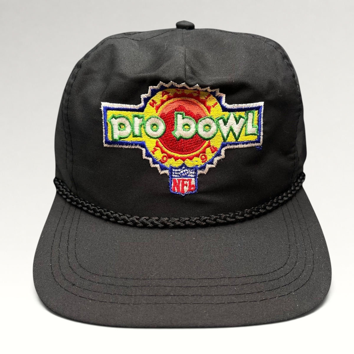 Raree Finds vintage black NFL Pro Bowl snapback hat with braided rope detail and colorful embroidered logo.