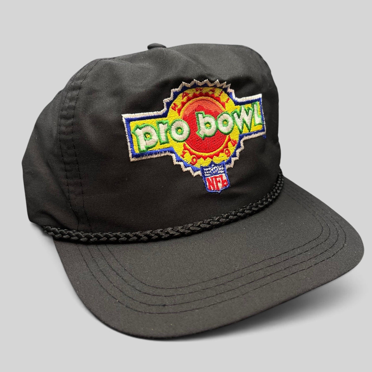 Raree Finds vintage black NFL Pro Bowl snapback rope hat with colorful embroidered sunburst logo and braided detail.
