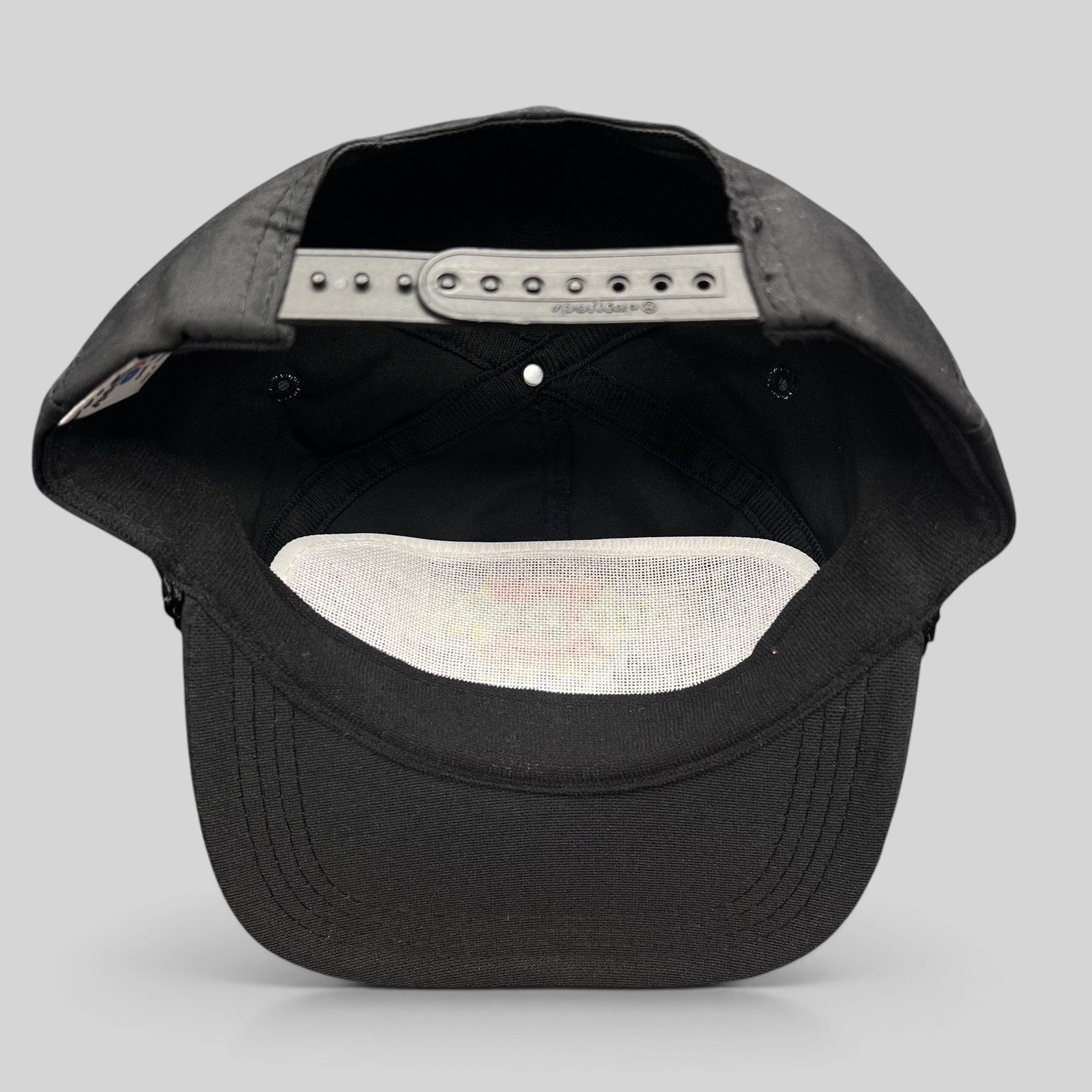 Raree Finds vintage black NFL Pro Bowl snapback hat showing the interior adjustable plastic strap and white mesh lining.