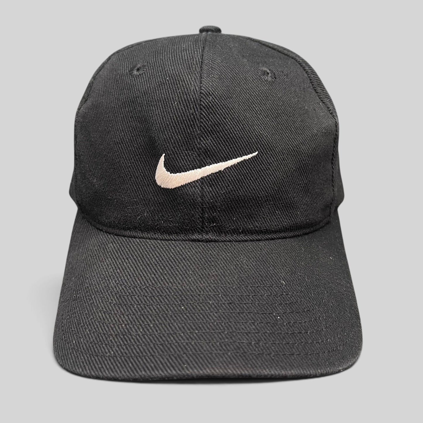 Raree Finds vintage 90s black cotton Nike snapback cap with an embroidered white Swoosh logo on the front panel