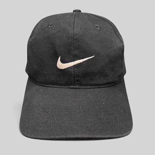 Raree Finds vintage 90s black cotton Nike snapback cap with an embroidered white Swoosh logo on the front panel