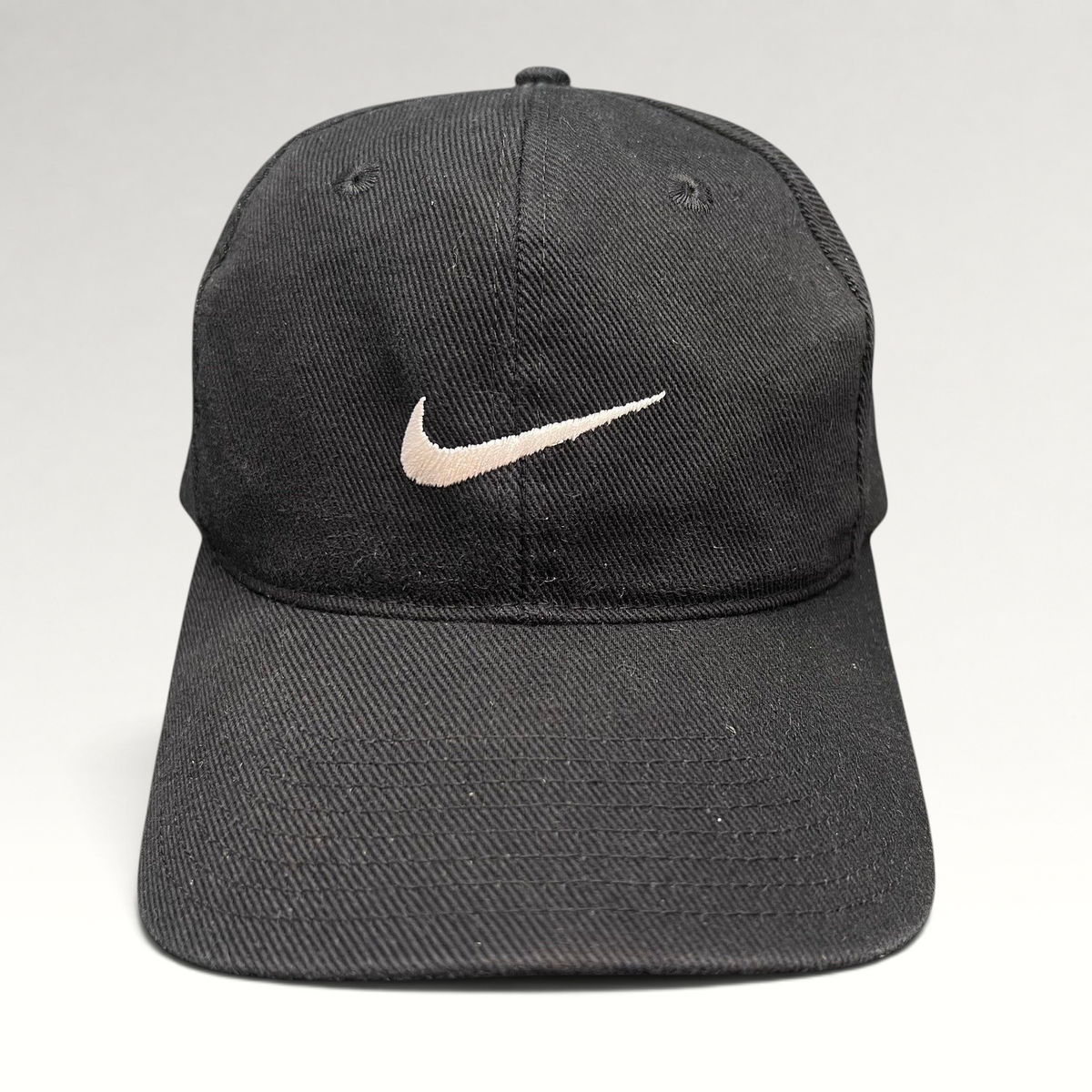Raree Finds vintage 90s black cotton Nike snapback cap with an embroidered white Swoosh logo on the front panel