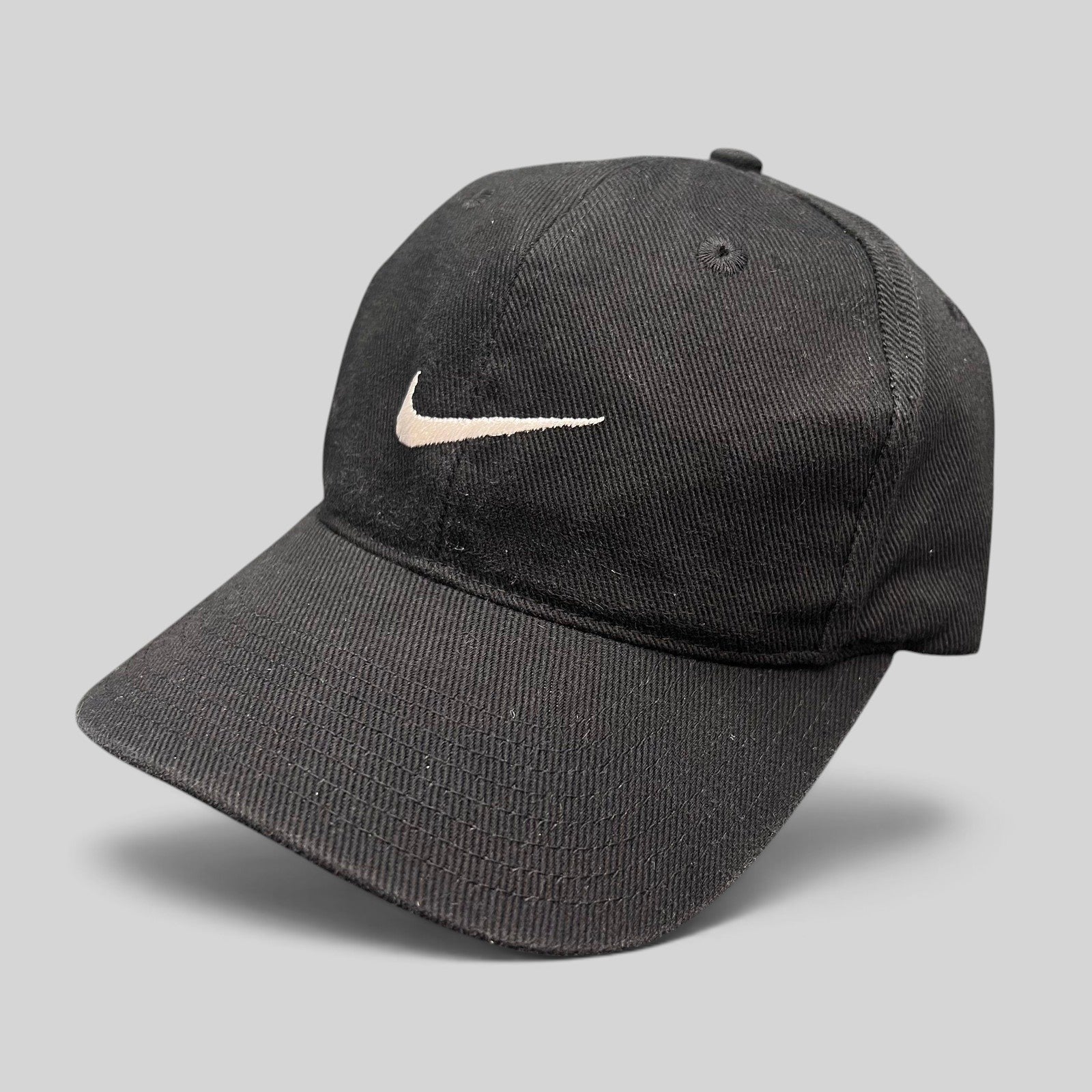 Raree Finds vintage black Nike snapback hat with white embroidered Swoosh logo on the front panel