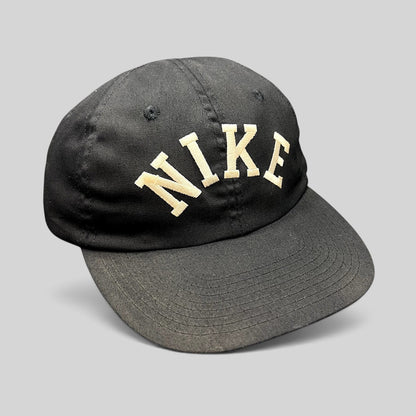 Raree Finds vintage black Nike strapback hat with arched embroidered spellout and classic green undervisor