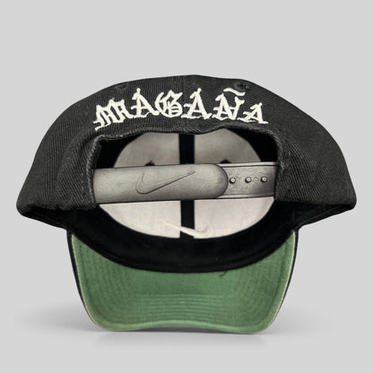 Raree Finds vintage 90s Nike snapback cap in black with Magaña script embroidered on the back and green undervisor.