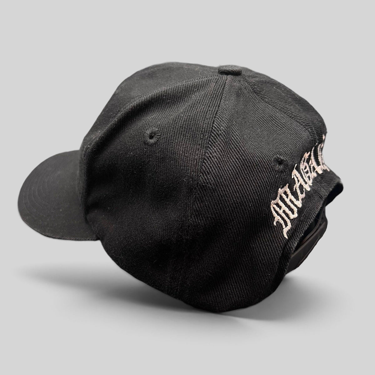 Raree Finds vintage 90s black Nike snapback hat with custom Magaña script embroidery on the back