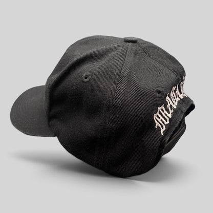 Raree Finds vintage 90s black Nike snapback hat with custom Magaña script embroidery on the back