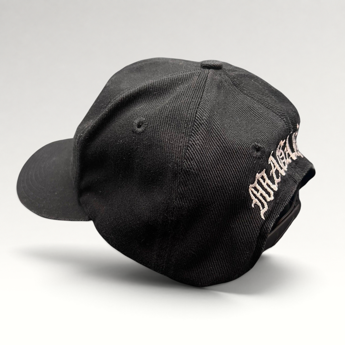 Raree Finds vintage 90s black Nike snapback hat with custom Magaña script embroidery on the back