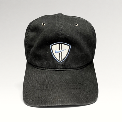 Raree Finds vintage black Nike soccer strapback hat with an embroidered shield crest and blue swoosh logo.
