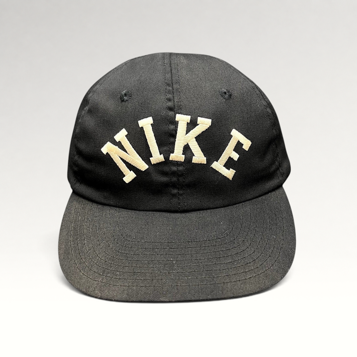 Raree Finds vintage black Nike strapback hat with an oversized arched embroidered spellout logo