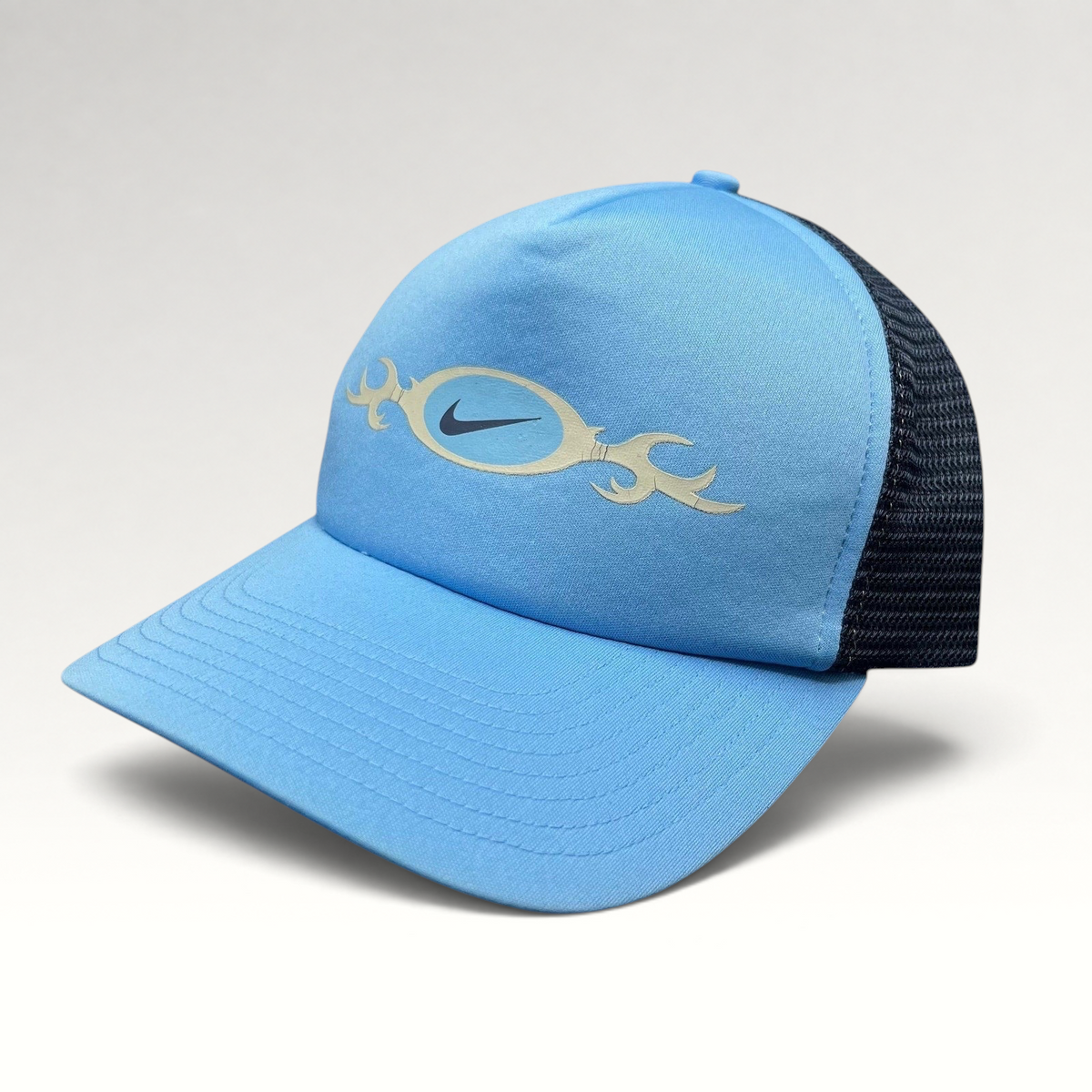 Raree Finds vintage light blue Nike trucker hat with navy mesh back and tribal oval swoosh logo graphic