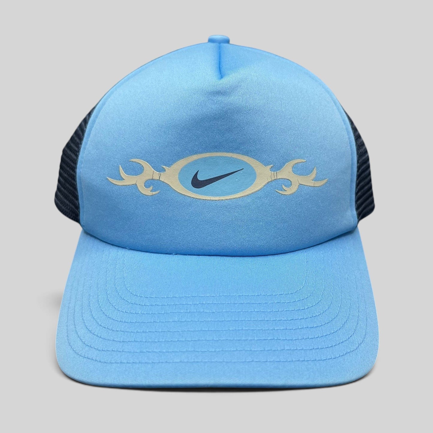 Raree Finds vintage light blue Nike trucker hat with a tribal oval swoosh graphic and navy mesh back panel