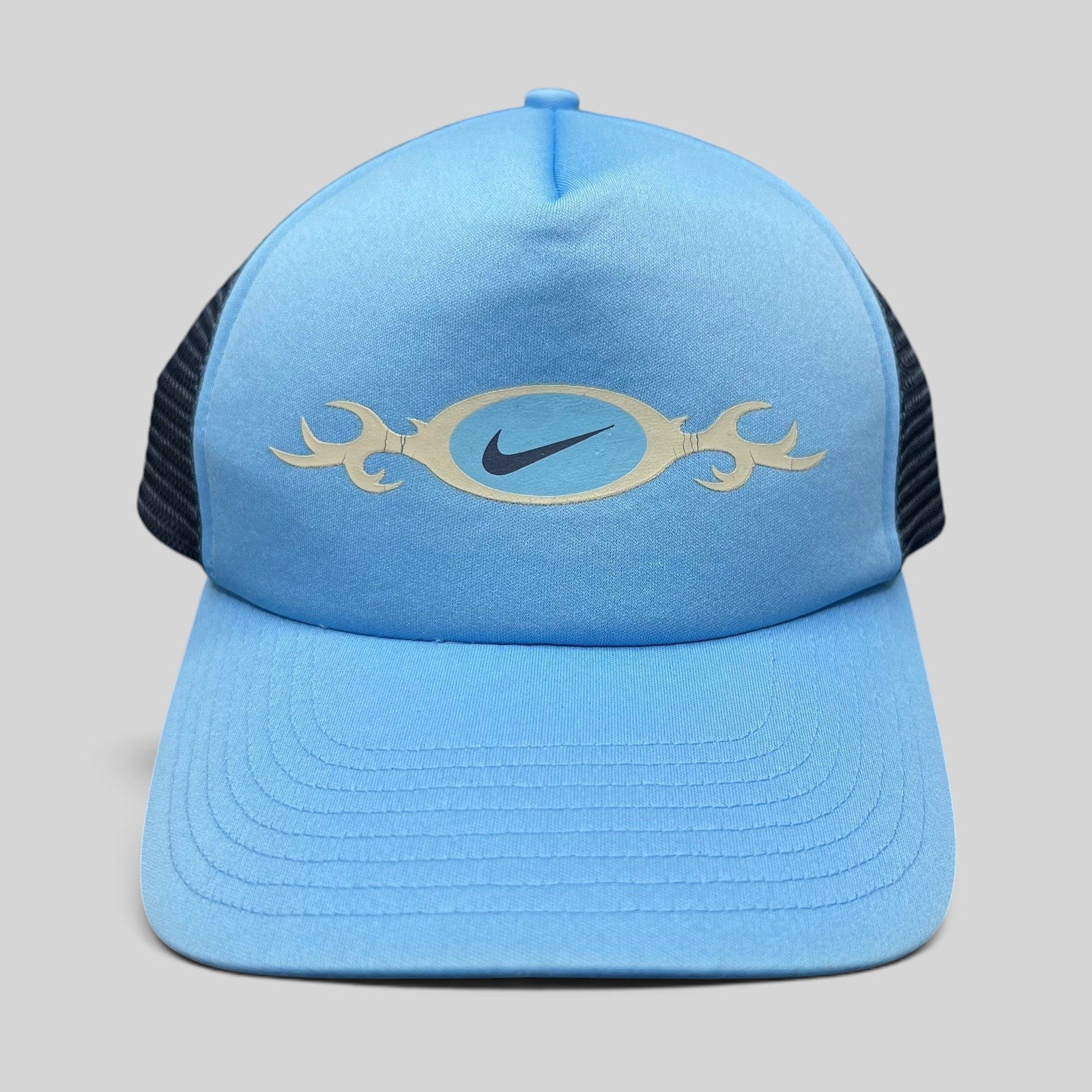 Raree Finds vintage light blue Nike trucker hat with a tribal oval swoosh graphic and navy mesh back panel