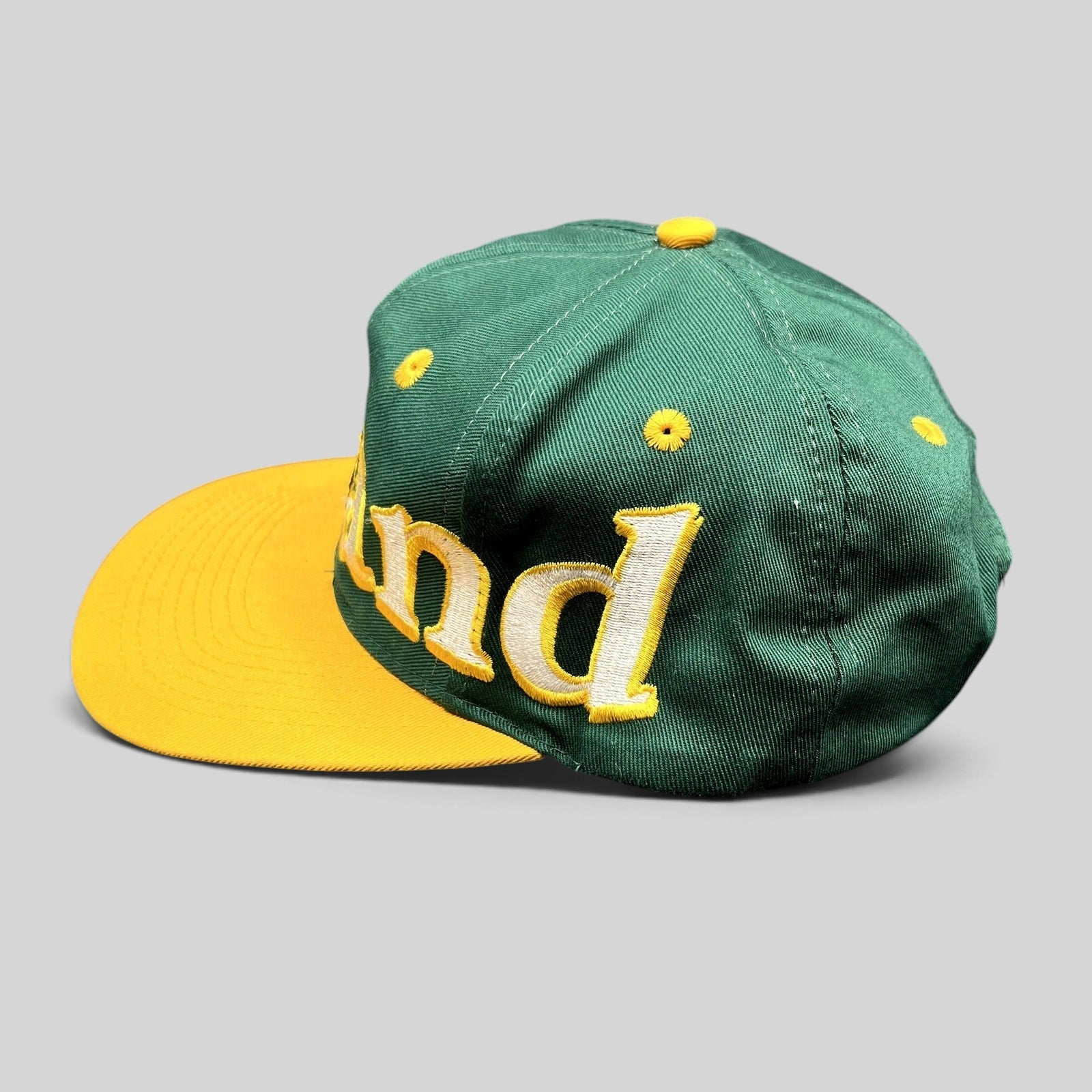 Raree Finds vintage 90s Oakland Athletics Logo 7 snapback hat in green and yellow with oversized script embroidery