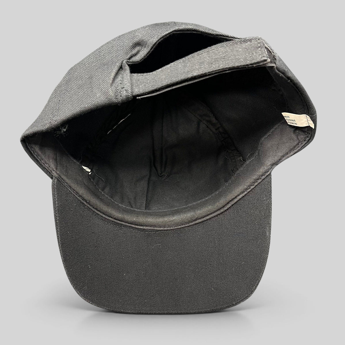 Interior view of a Raree Finds vintage 1993 Oktoberfest Munich black cotton strapback cap showing the adjustable strap
