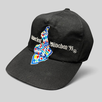 Raree Finds vintage 1993 Oktoberfest Munich black cotton strapback hat with colorful Bavarian geometric embroidery.