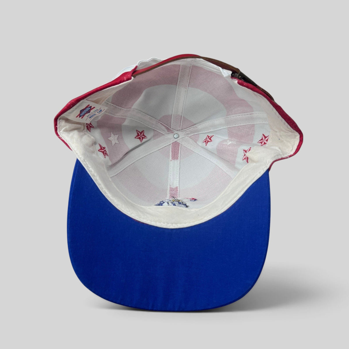 Raree Finds vintage Nissin Cap patriotic USA Olympics hat interior showing flag print lining and brass buckle strap