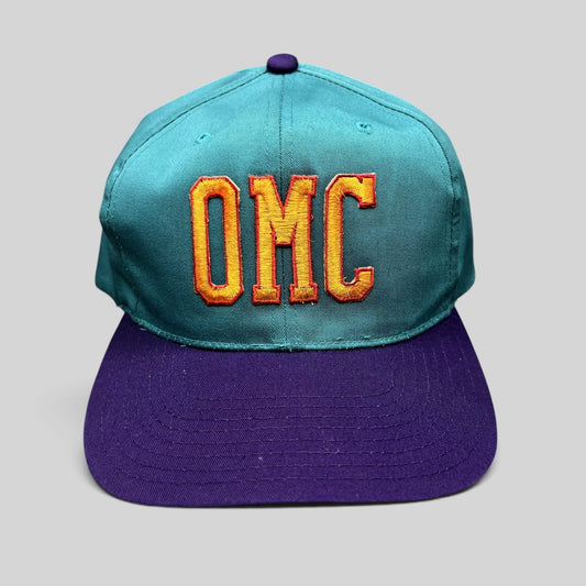 Raree Finds vintage 90s OMC snapback hat with teal crown, purple brim, and orange embroidered lettering