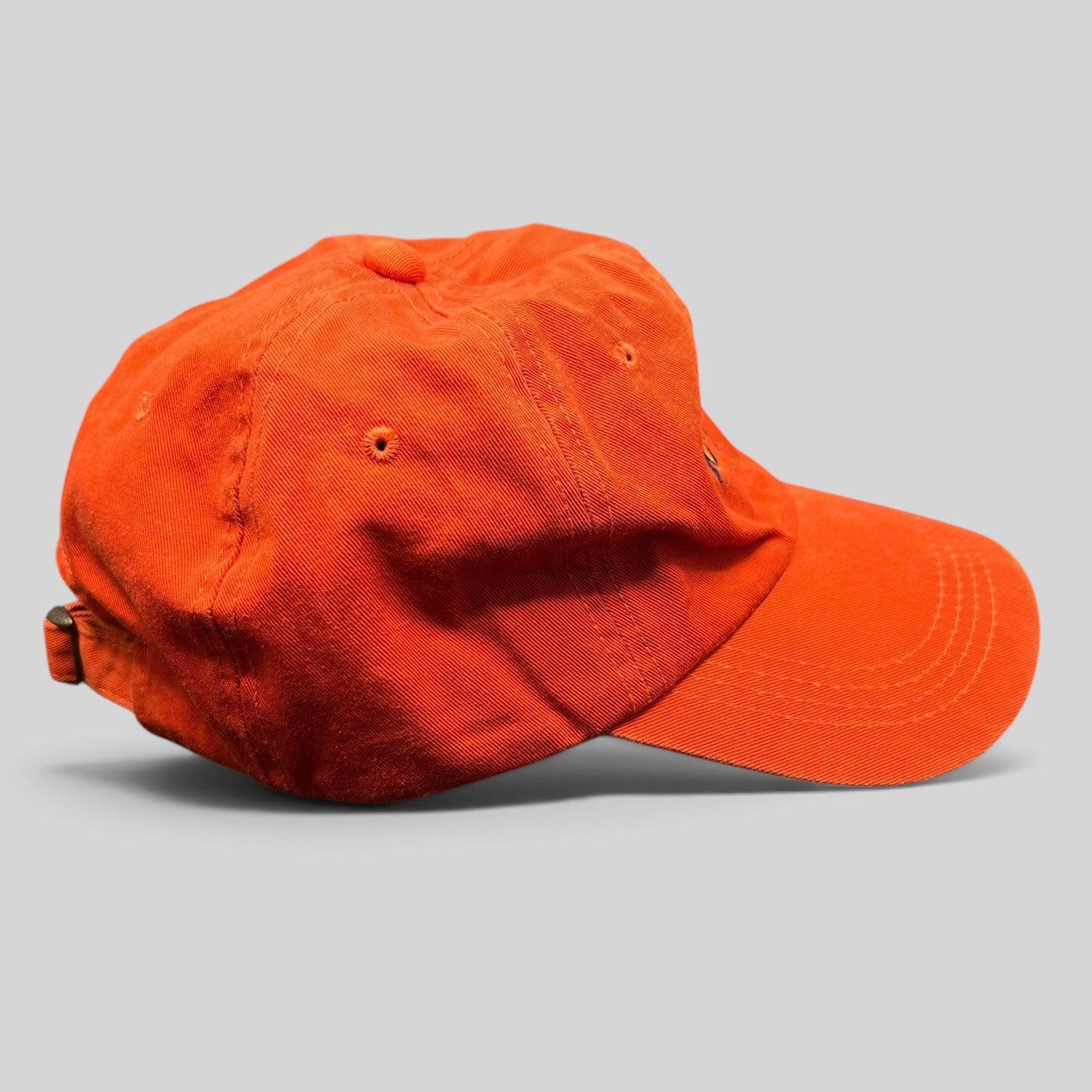 Raree Finds vintage orange cotton strapback dad cap with embroidered St. Francis script logo and curved brim