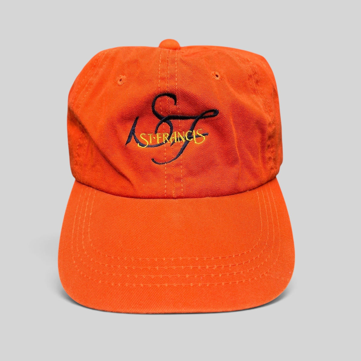 Raree Finds vintage orange cotton strapback hat with embroidered St. Francis script logo and curved brim