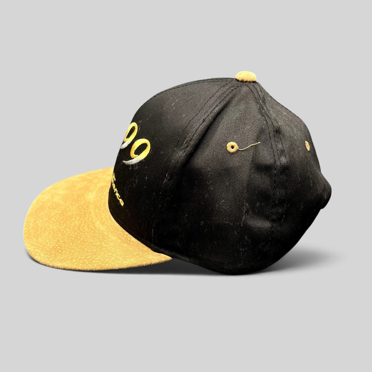 Raree Finds vintage Y2K Paris France snapback hat with a black crown and tan suede brim, side profile view.