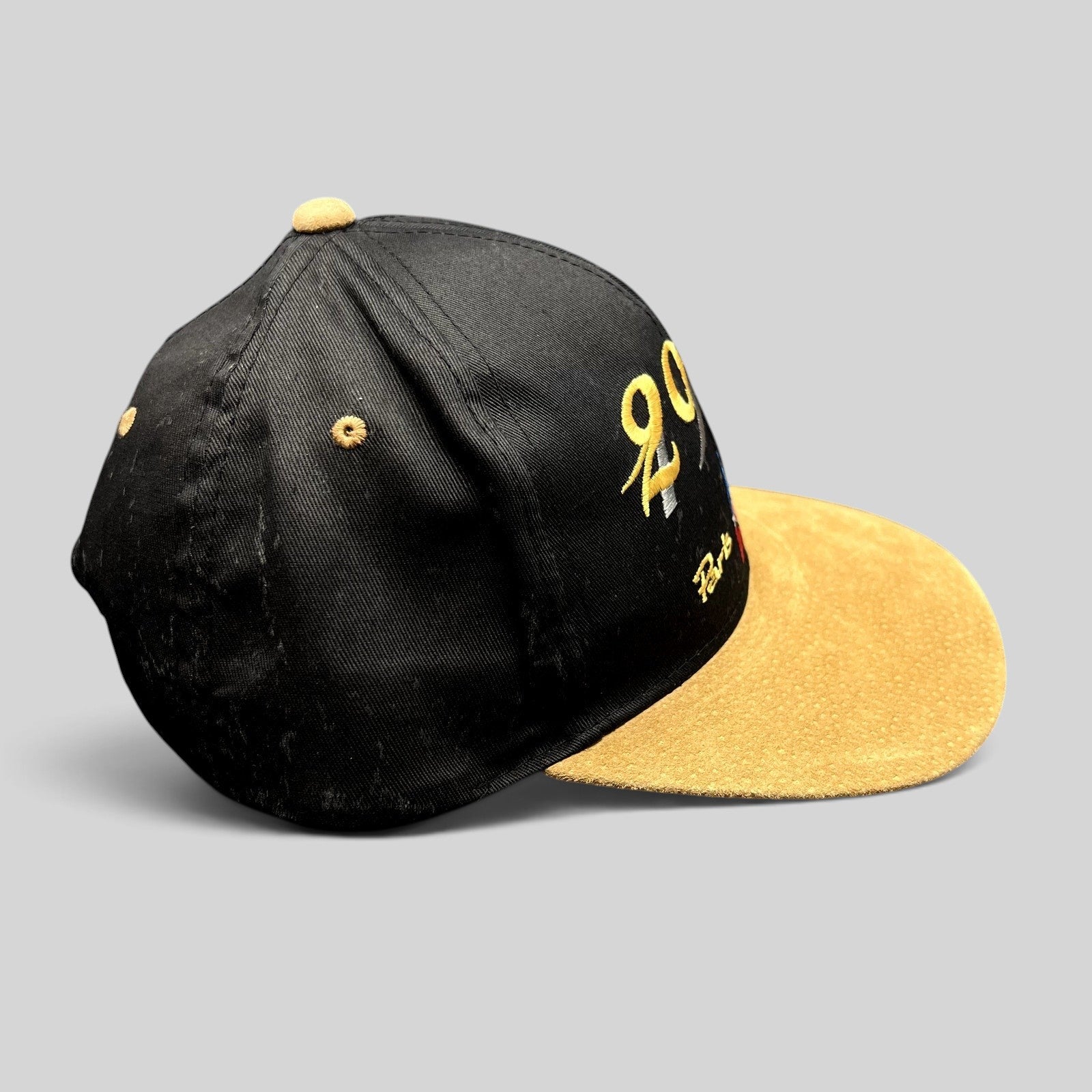 Raree Finds vintage Y2K Paris France snapback hat with a black crown and tan suede brim featuring 2000 embroidery.
