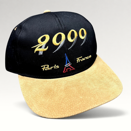 Raree Finds vintage Y2K Paris France snapback hat with black crown, tan suede brim, and 2000 Eiffel Tower embroidery.