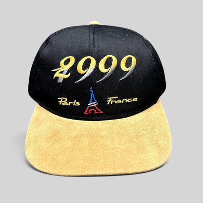 Raree Finds vintage Y2K Paris France snapback hat with black crown, tan suede brim, and 2000 Eiffel Tower embroidery.