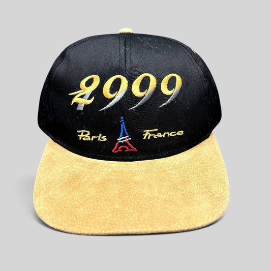 Raree Finds vintage Y2K Paris France snapback hat with black crown, tan suede brim, and 2000 Eiffel Tower embroidery.