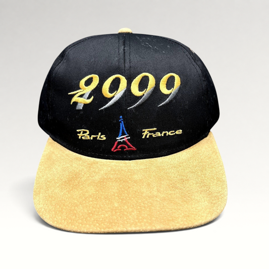 Raree Finds vintage Y2K Paris France snapback hat with black crown, tan suede brim, and 2000 Eiffel Tower embroidery.