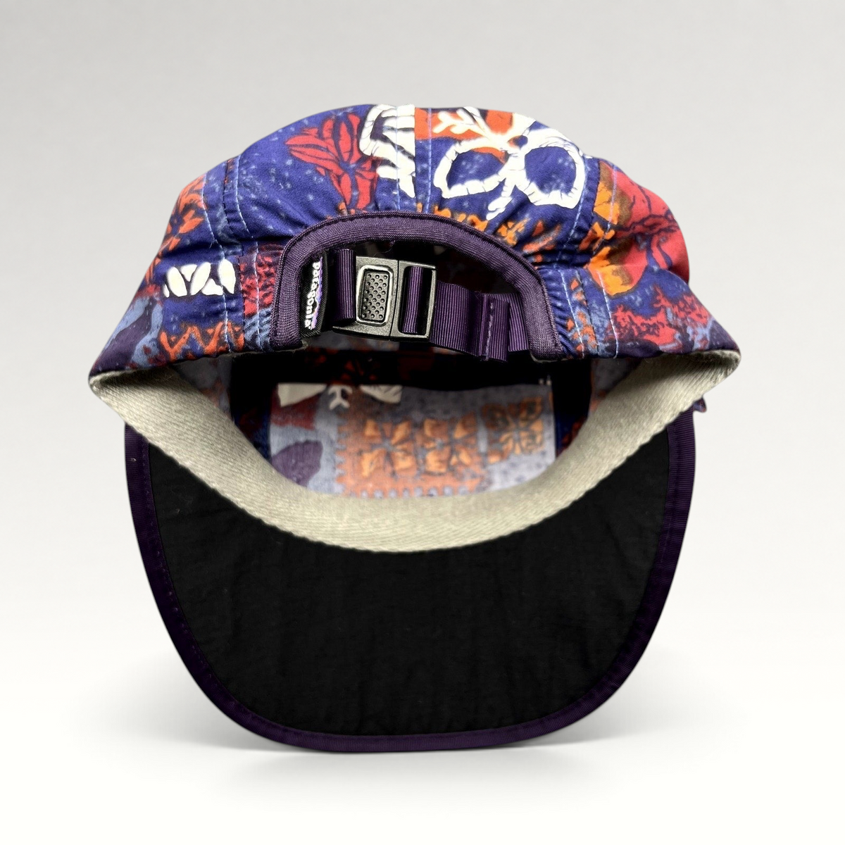 Raree Finds vintage 1996 Patagonia Spoonbill cap with purple tropical print, adjustable strapback, and foldable bill.