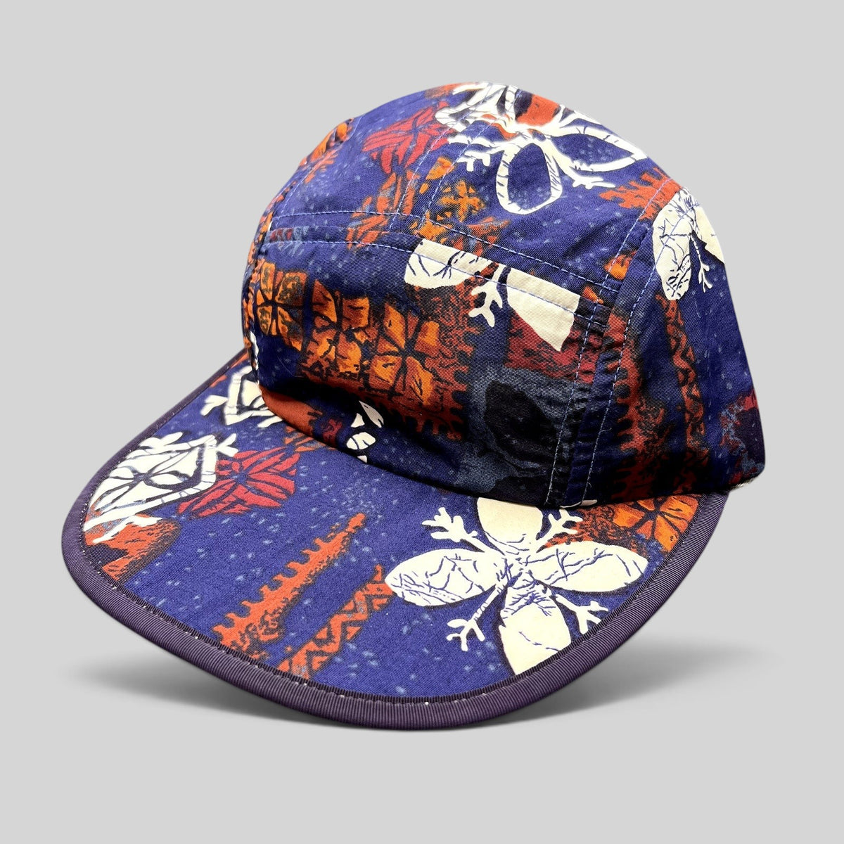 Raree Finds vintage 1996 Patagonia Spoonbill cap in purple tropical print with a soft packable bill and strapback.