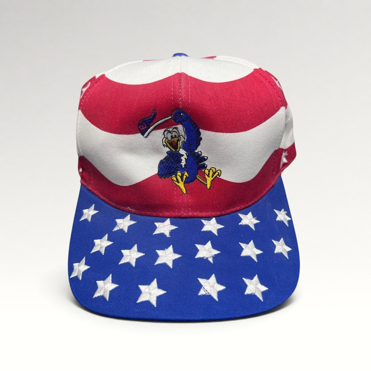 Raree Finds vintage Nissin Cap patriotic hat with embroidered eagle, American flag stripes, and star-patterned brim.