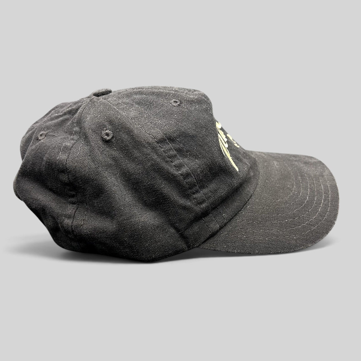 Raree Finds vintage black Pearl Vodka promotional snapback hat with embroidered logo and curved brim, side profile.