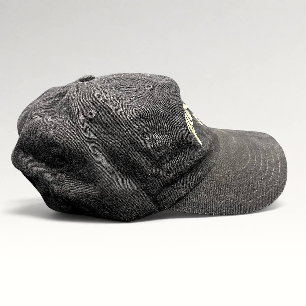 Raree Finds vintage black Pearl Vodka promotional snapback hat with embroidered logo and curved brim, side profile.