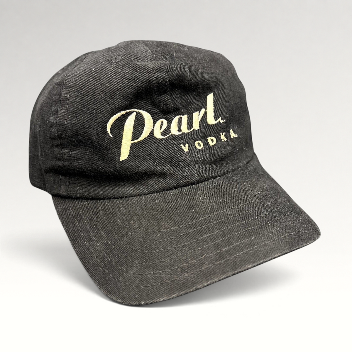 Raree Finds vintage black Pearl Vodka promotional snapback hat with cream embroidered logo and curved brim