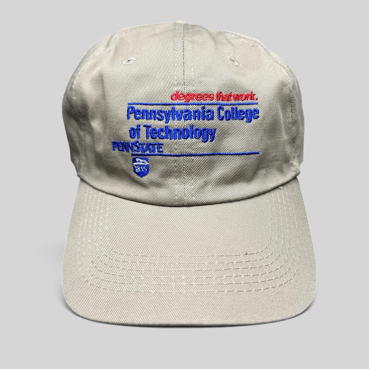Raree Finds vintage khaki strapback hat with Pennsylvania College of Technology and Penn State embroidered graphics.