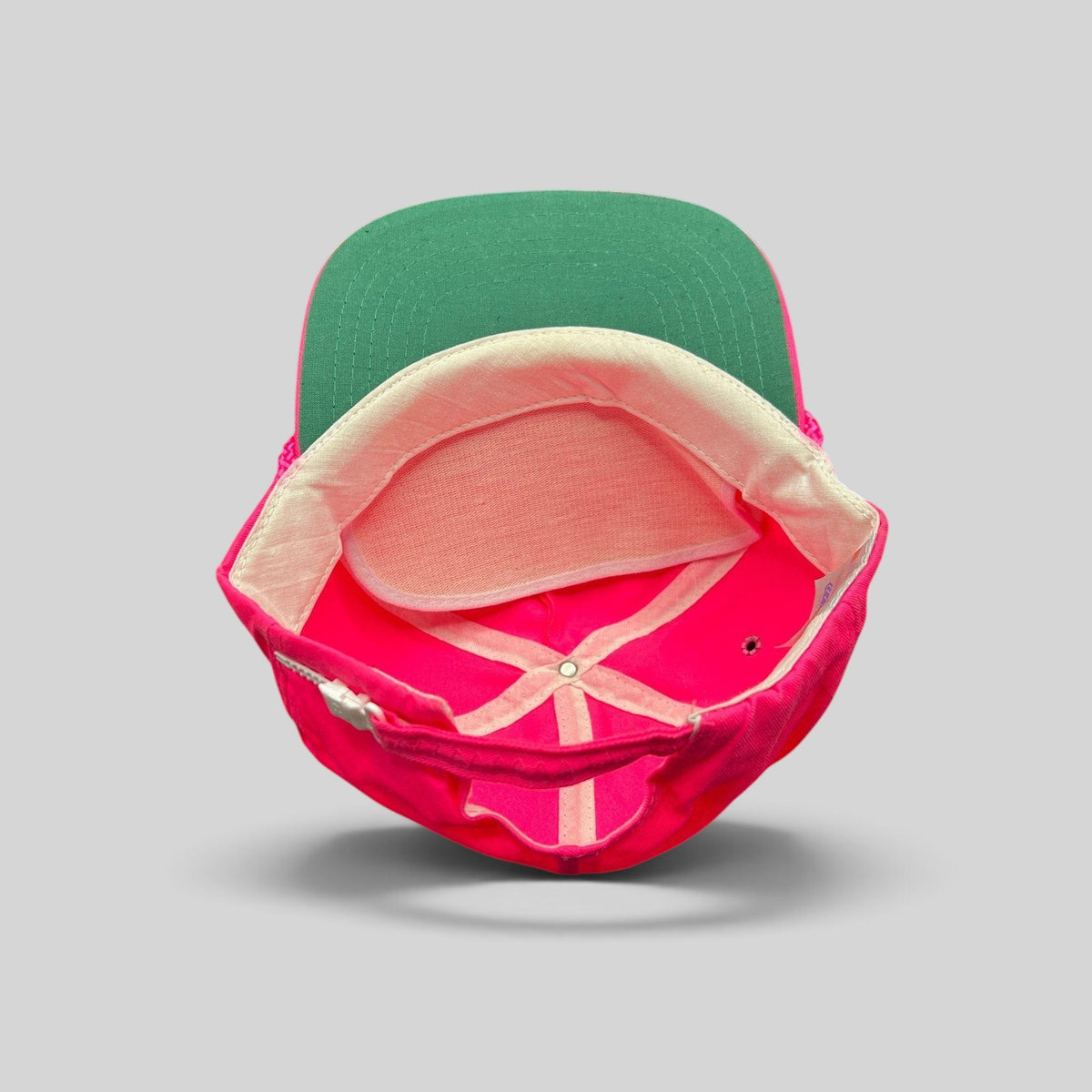 Raree Finds vintage 1980s neon pink zipperback hat with a green undervisor and interior structure detail